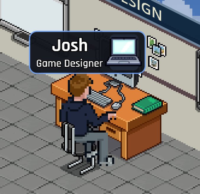 Josh, Game Designer, at his desk with his name tag over his head